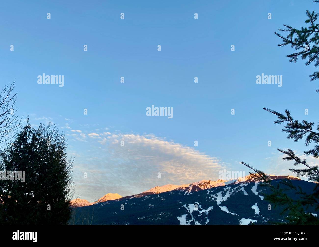 Snowy Mountain Slopes at Sunrise with Cloud Formation - Smartphone Captured Stock Image