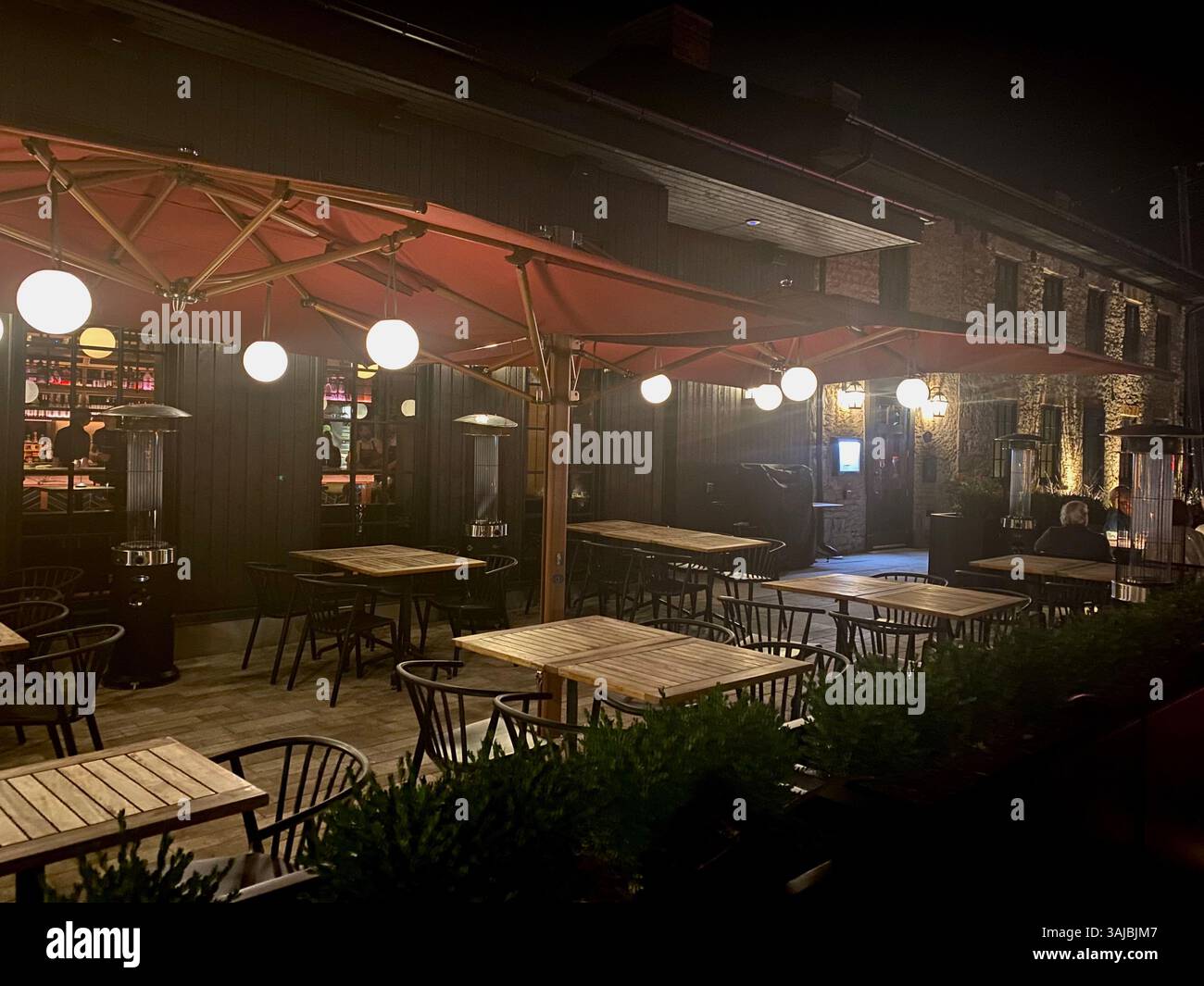 Outdoor Restaurant Patio at Night with Umbrella Lights - Smartphone Captured Stock Image