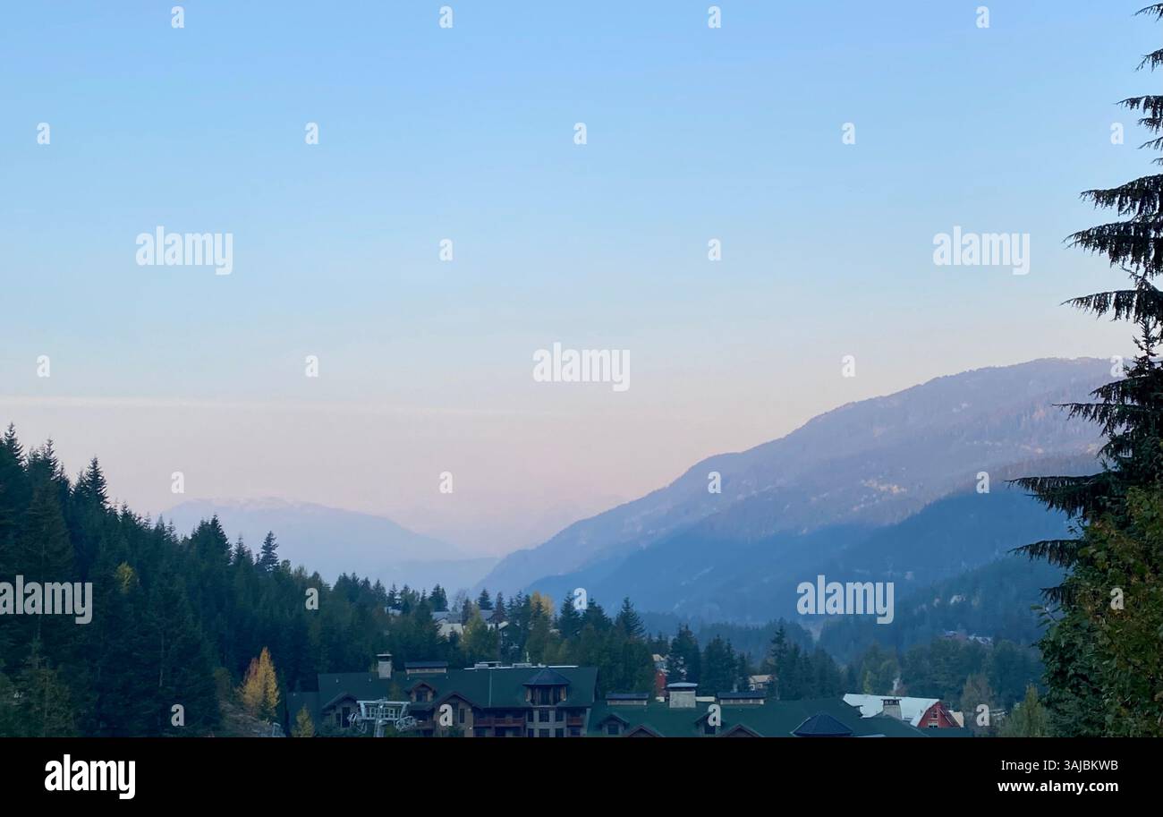 Mountain Valley View with Buildings and Forest at Dusk - Smartphone Captured Stock Image