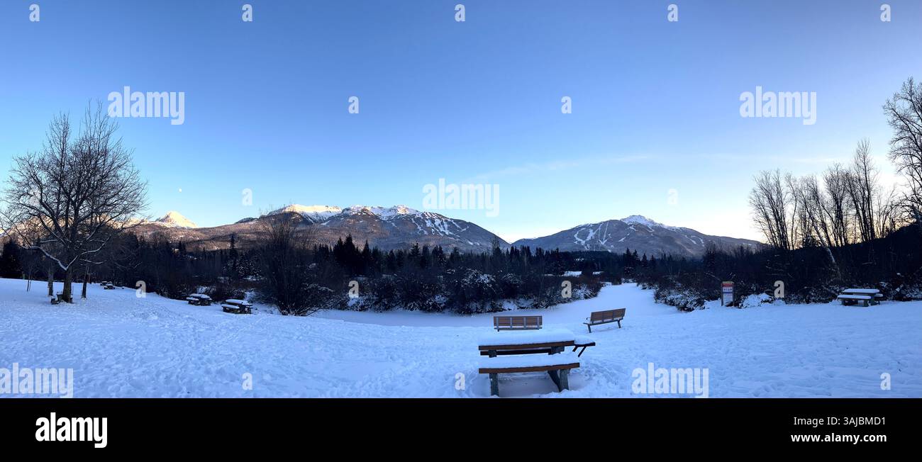 Snow-Covered Park with Mountain View and Benches - Smartphone Captured Stock Image