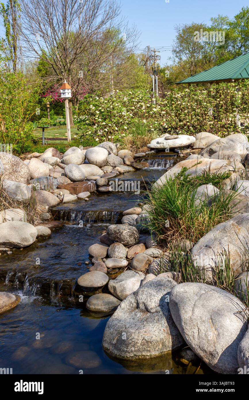 Small waterfall flowing through a landscaped rock garden stream ...
