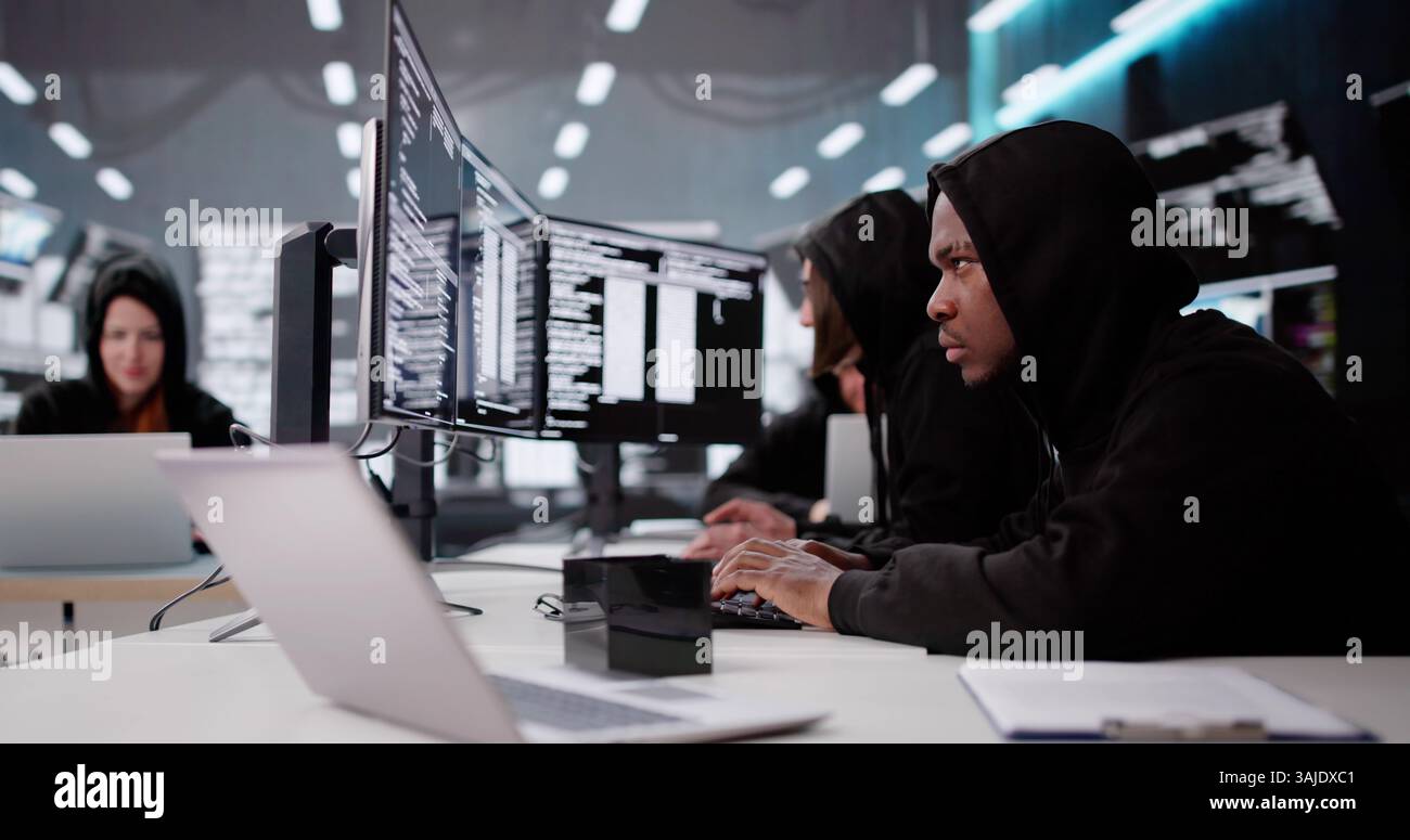 Cyber Criminals Stealing Secure Data And Information. Programmer Hacking Software. Spy Hacker Stealing Secure Data Stock Photo