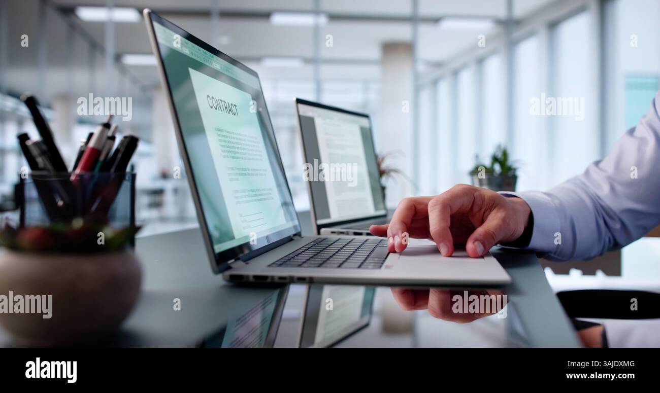Reading Lease Agreement Contract Document On Laptop Computer Stock Photo