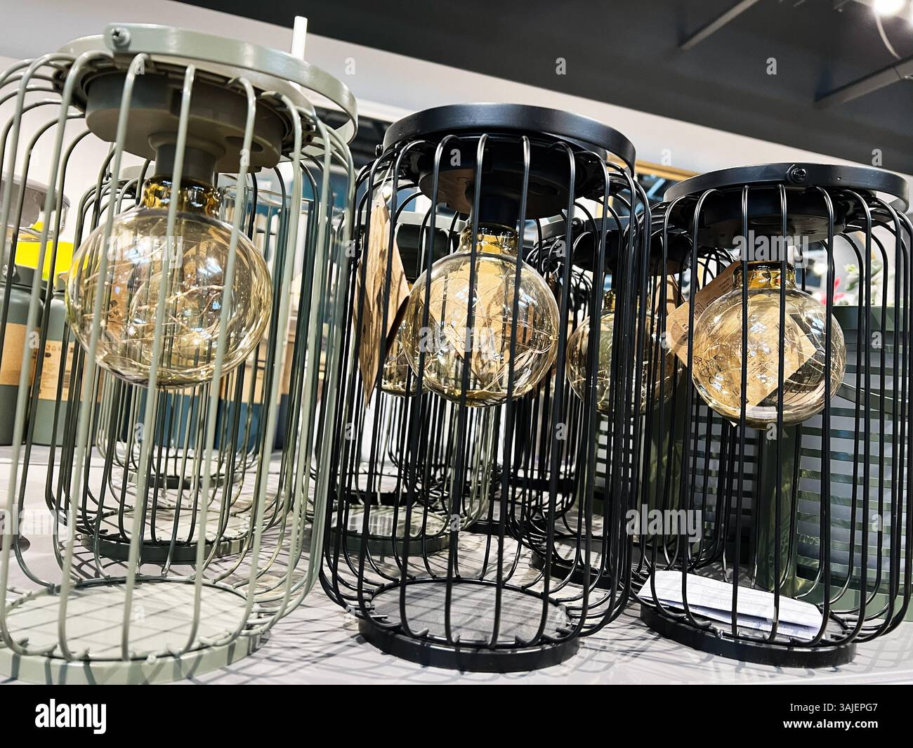 Contemporary decorative light fixtures featuring glass bulbs and cage ... - Cage Design For Fitting Uv Lighting Fixtures
