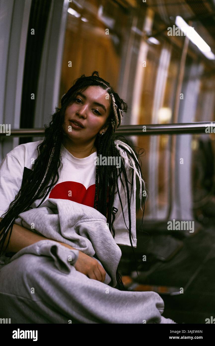 Woman sitting on subway hi-res stock photography and images - Alamy