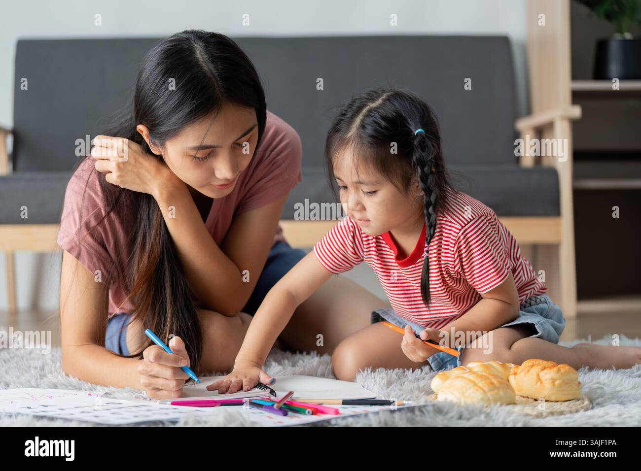 Learning and Bonding. A mother and daughter engaging in creative ...