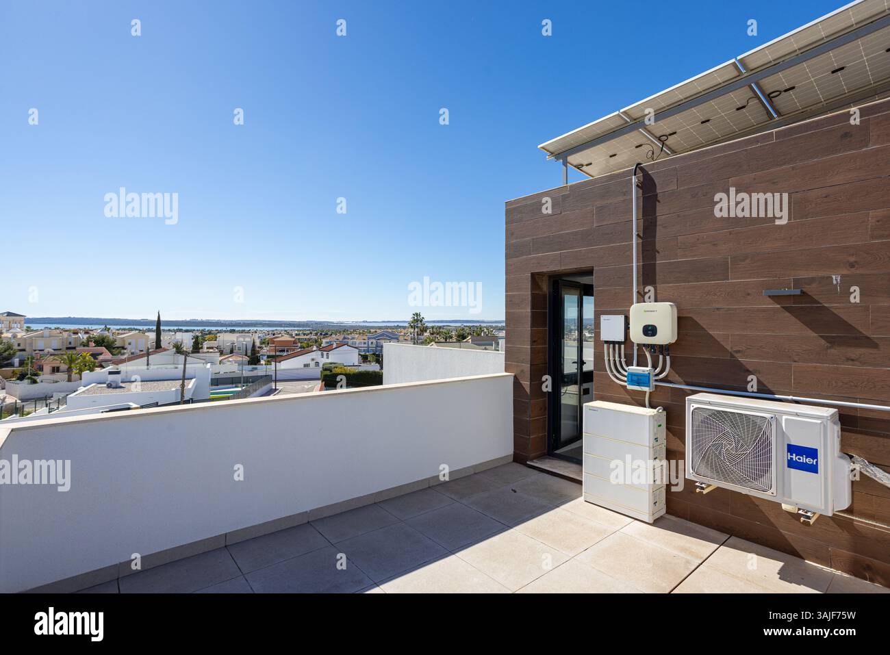 Modern rooftop terrace featuring solar panels, air conditioning units
