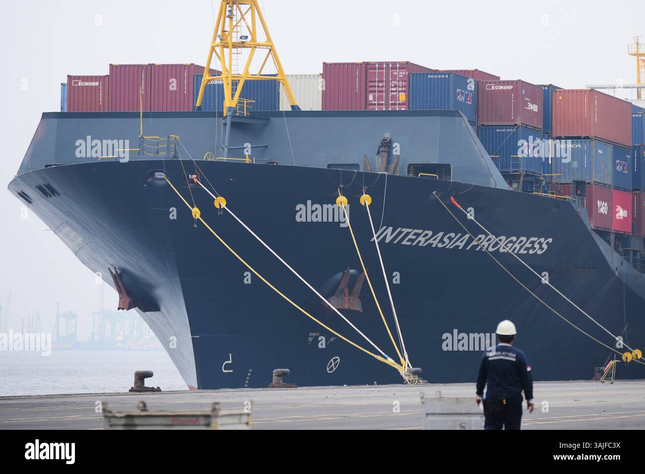 FILE - Shipping containers are stacked on a cargo ship docked at ...