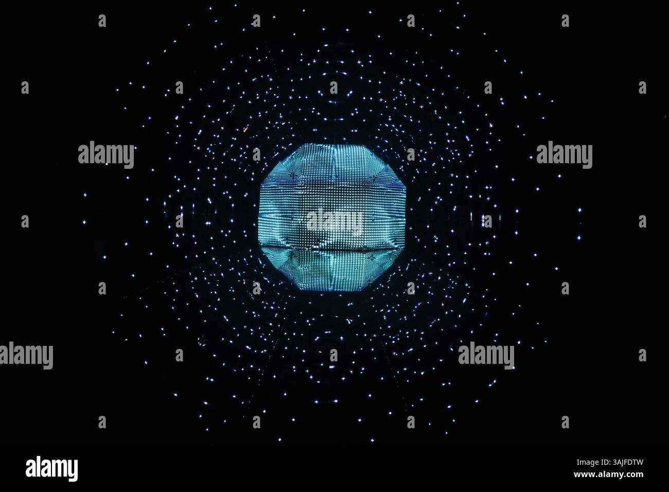 Futuristic glowing blue geometric sphere with floating particles Stock Photo
