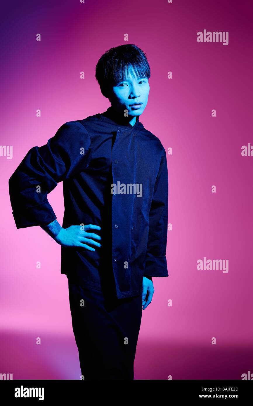 A young and handsome asian man stands confidently in a stylish outfit ...