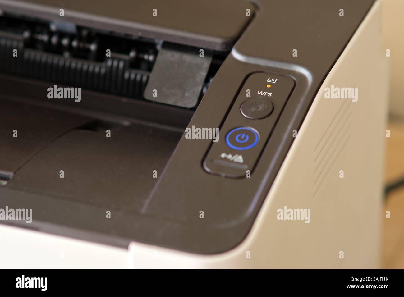 Close-up of laser printer control panel with orange toner alert ...
