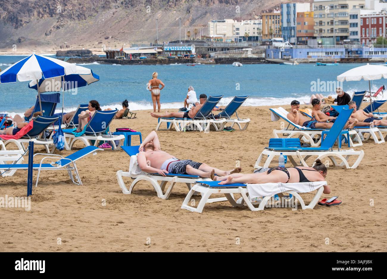 Las Palmas, Gran Canaria, Canary Islands, Spain. 11th April, 2025. Tourists, many British, sunbathe on the city beach in Las Palmas in the wake of storm Olivier. The storm covered Spain's highest mountain, mount Teide on Tenerife, in a blanket of snow. Credit: Alan Dawson/Alamy Live News Stock Photo
