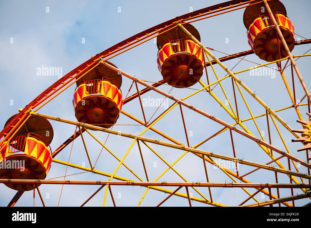 Ferris wheel with colorful cabins rotating in amusement park in Crimea ...