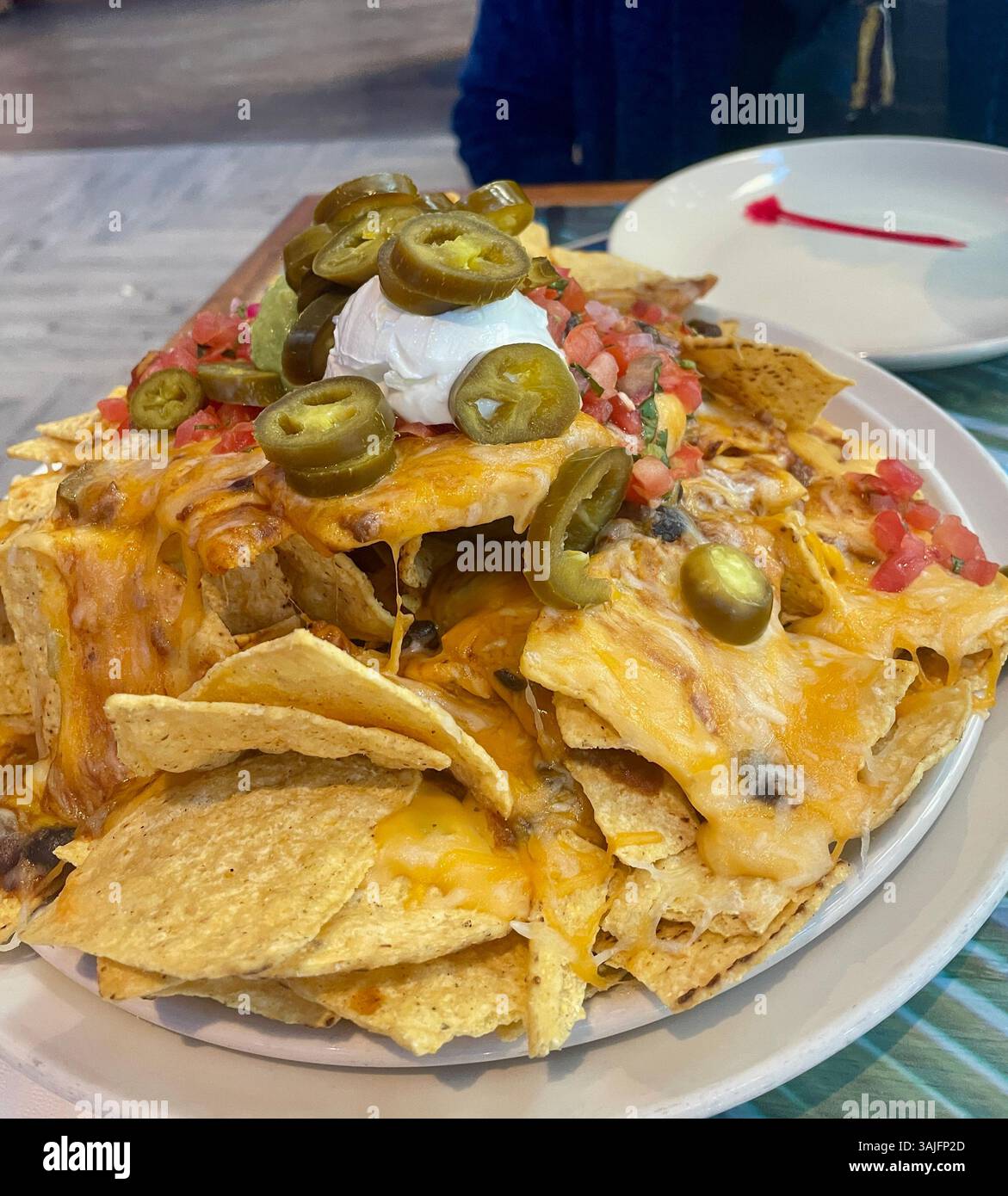 The Volcano Nachos Served at Margaritaville Resort Times Square, a Jimmy Buffett property in New York City, USA  2025 - Smartphone Captured Stock Image
