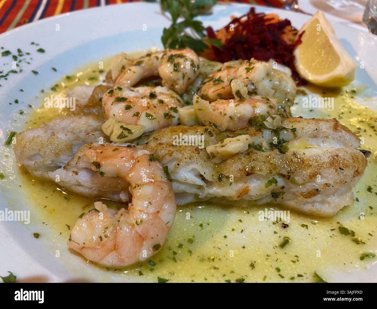 A tasty dish of Madeiran black scabbard fish and prawns in a rich butter and cream sauce. - Smartphone Captured Stock Image