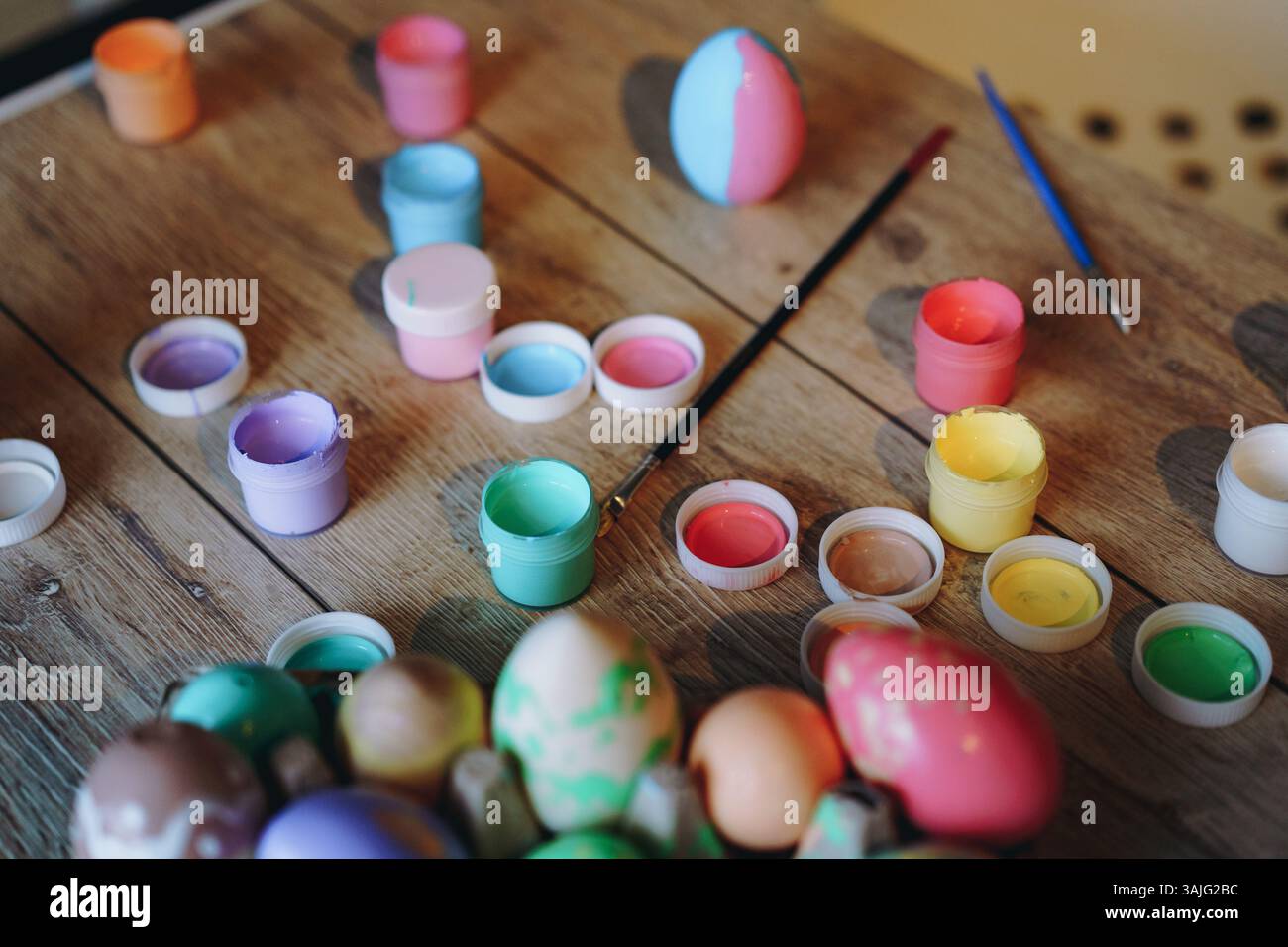 handmade coloured eggs and acrylic paint. Easter flatlay Stock Photo