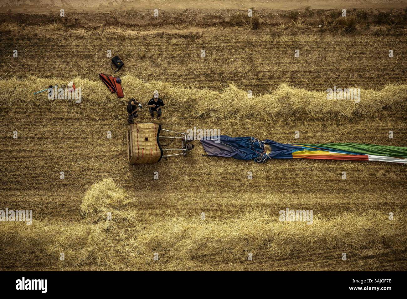 July 6, 2017 - A hot air balloon has been folded after landing next to a field path after a first flight at the 21st European Balloon Festival. The first flight at the 21st edition of Igualada's four day long European Balloon Festival, the biggest concentration, competition and festival of hot air balloons in Spain featuring over 50 international teams, are underway. (Credit Image: © Matthias Oesterle via ZUMA Wire) Stock Photo