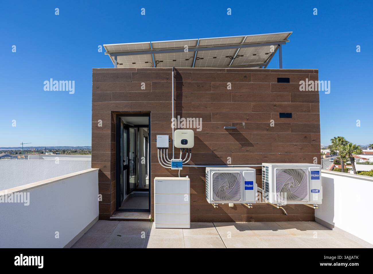 Rooftop view showing modern solar panel installation and mounted HVAC ...