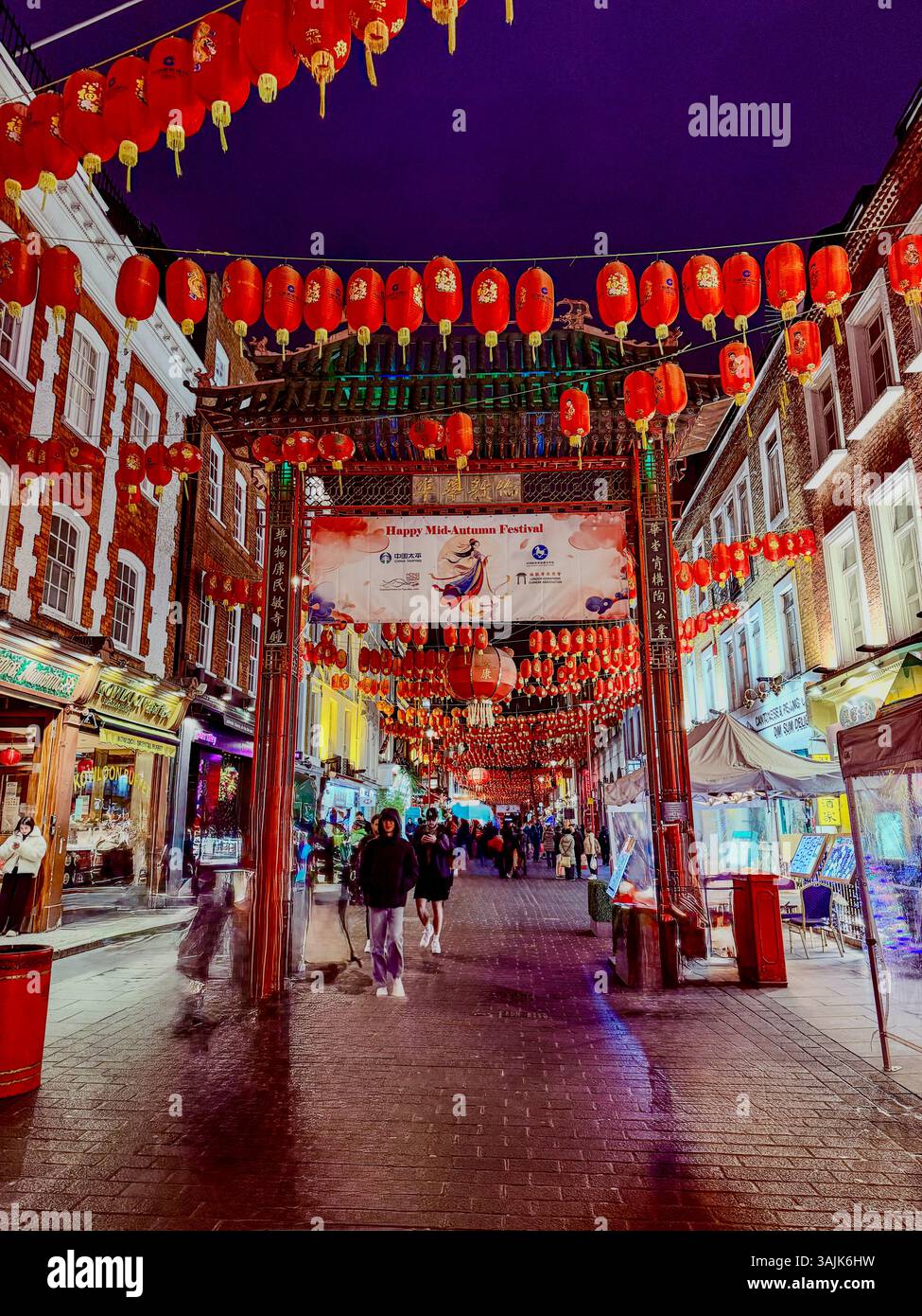 A festive stroll on a dazzling night under the lantern-lit streets of London Chinatown! Stock Photo