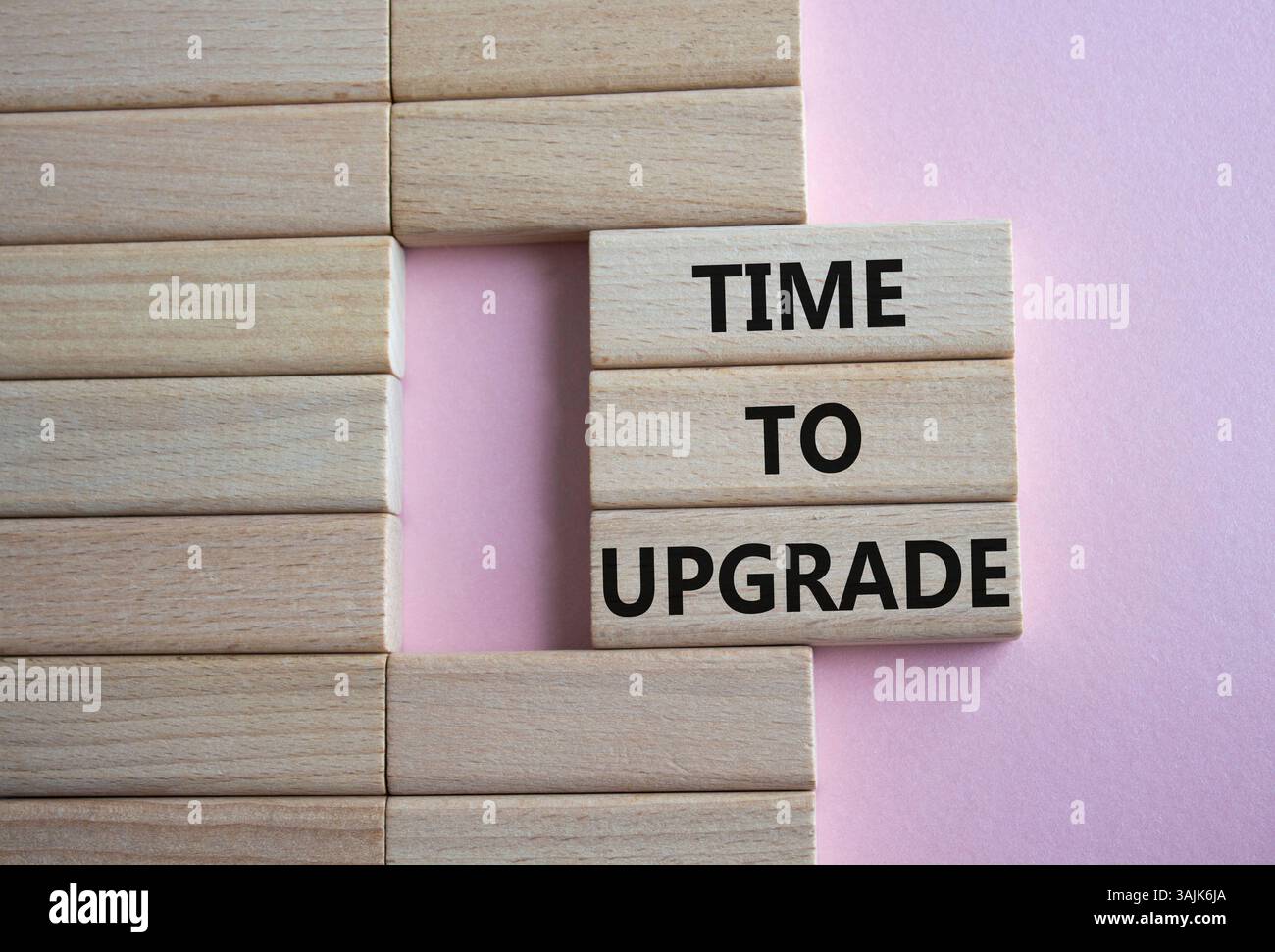 Time to Upgrade symbol. Concept words Time to Upgrade on wooden blocks. Beautiful pink background. Business and Time to Upgrade concept. Copy space. Stock Photo
