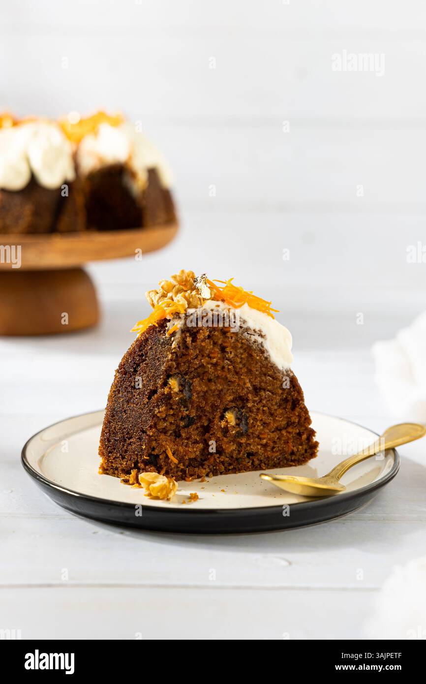 Carrot Cake with Cream Cheese Frosting and Fresh Flowers – White Wooden Background Stock Photo