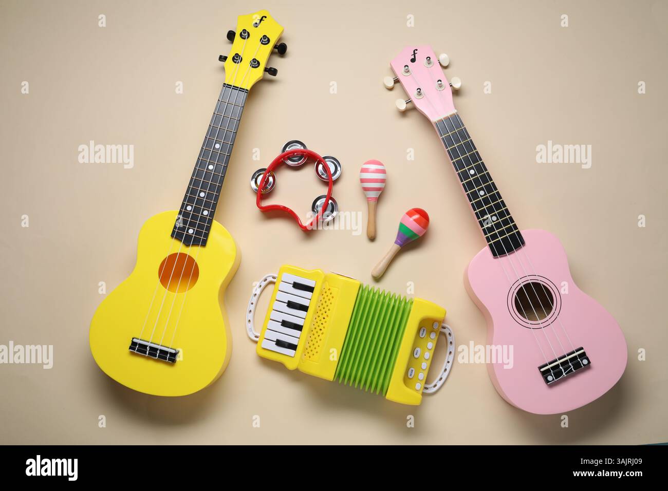 Flat lay composition with different toy musical instruments on beige ...