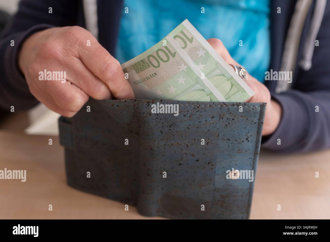 Woman takes euro notes out of a wallet Stock Photo