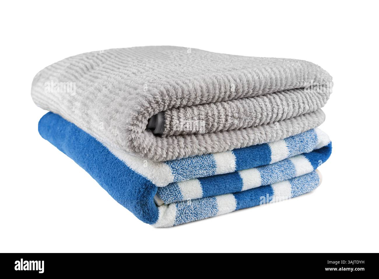 Soft fluffy striped grey and blue bath towels folded in stack isolated on white background. Terry cloth, striped pattern towel texture, cotton bath te Stock Photo