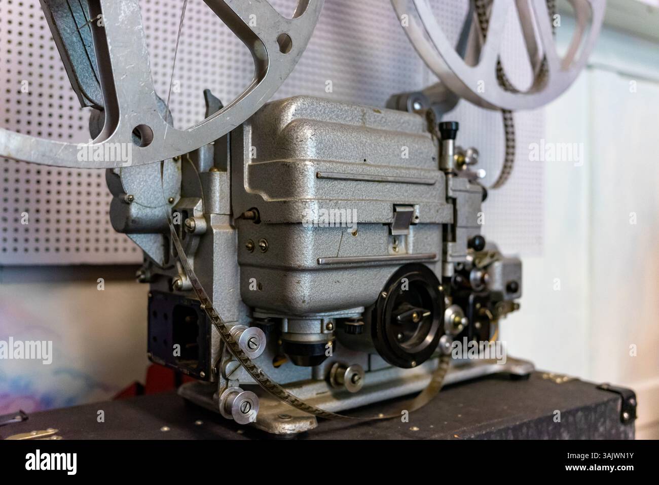 An antique film projector stands prominently on display, showcasing ...