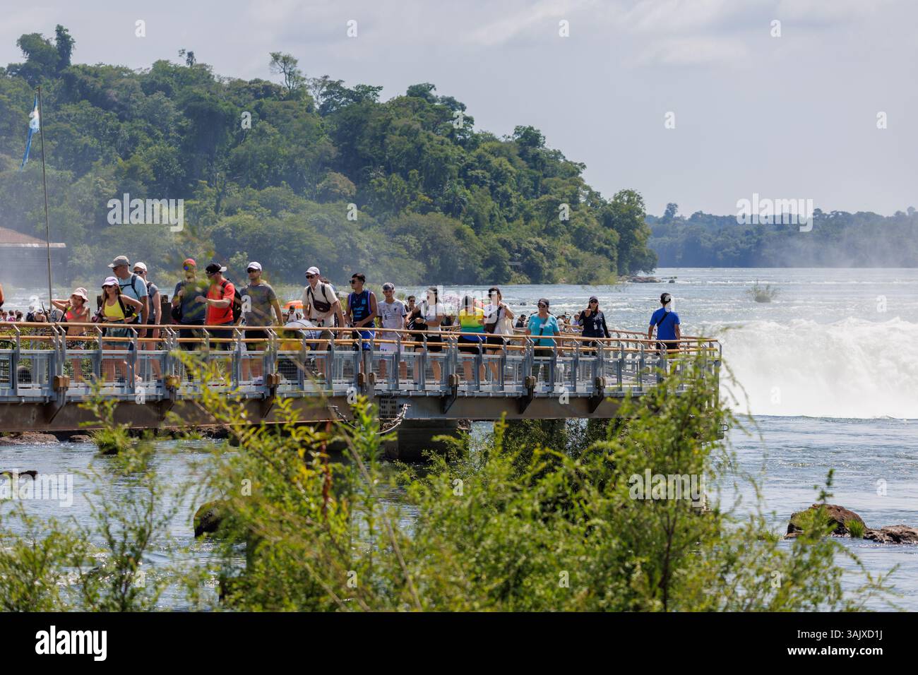Puerto Iguazu, Misiones, Argentina - April 5th, 2025: Tourists watching the Devil's Throat waterfall at Iguazu Falls. Stock Photo