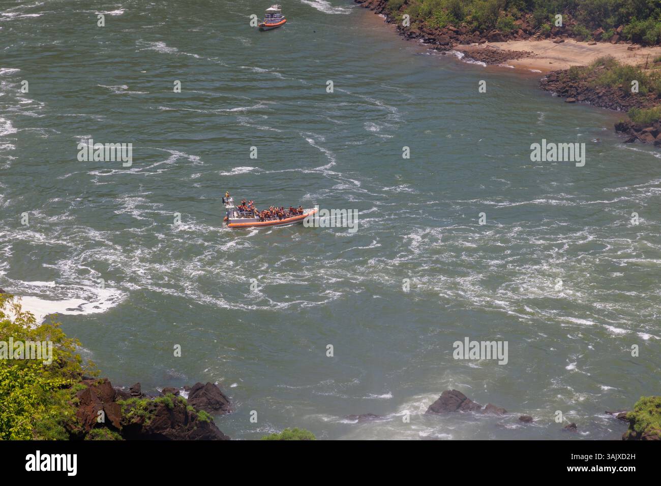 Puerto Iguazu, Misiones, Argentina - April 5th, 2025: Tourists enjoying a boat ride on the Iguazu River in Argentina. Stock Photo