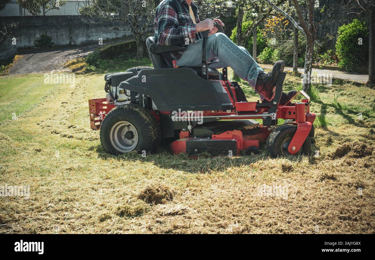 Man on riding lawn mower Stock Photo - Alamy
