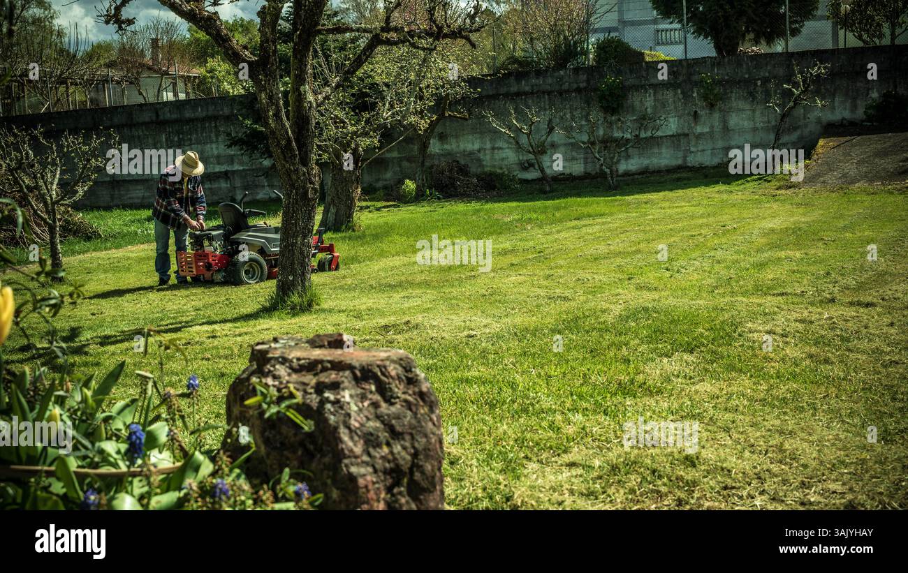 Man on riding lawn mower Stock Photo - Alamy