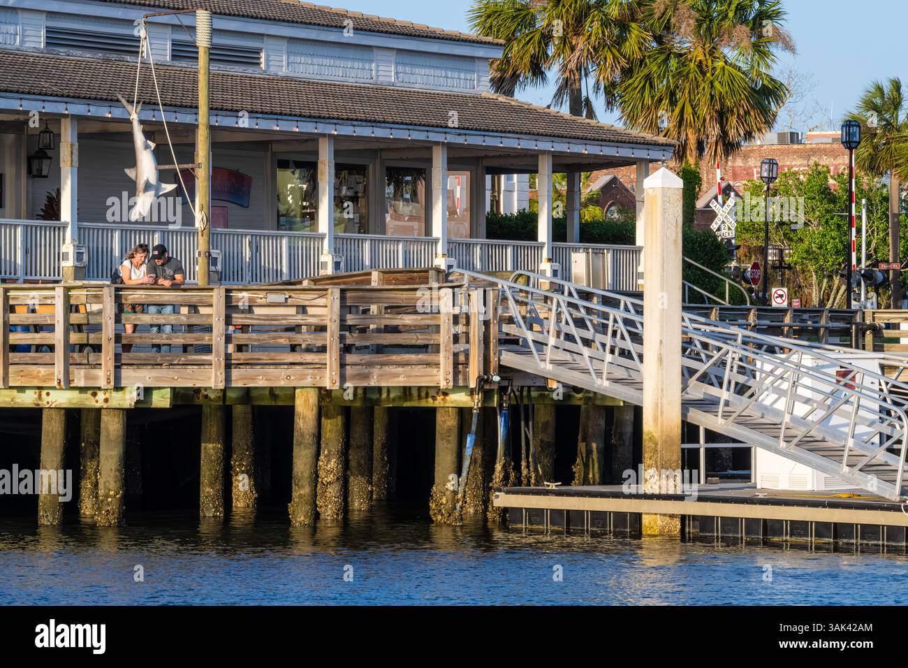 Couple enjoying a sunset at Fernandina Harbor Marina on the Intracoastal Waterway on Amelia Island in Fernandina Beach, Florida. (USA) Stock Photo