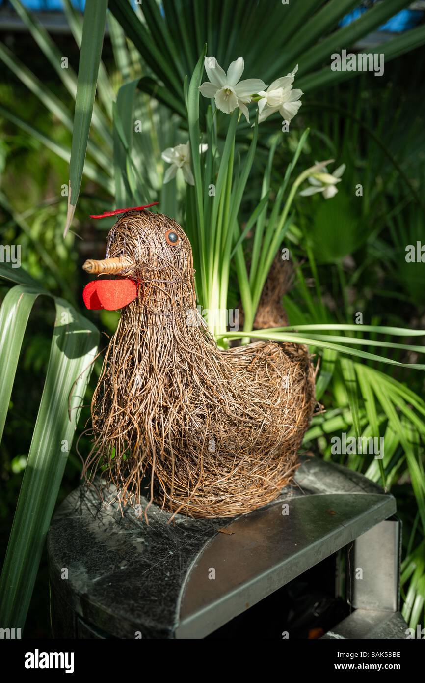 Handmade decorative chicken figure and pastel eggs in garden setting ...