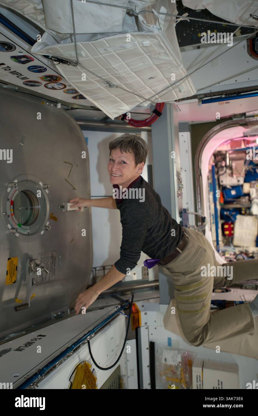December 13, 2016 - Earth orbit - NASA Expedition 50 prime crew member astronaut Peggy Whitson works inside the International Space Station Harmony module to open the hatchway for the Japanese HTV-6 cargo craft December 13, 2016 in Earth orbit. Launched from the Tanegashima Space Center, HTV-6 arrived at the space station with more than 4.5 tons of supplies. (Credit Image: © Nasa/NASA via ZUMA Wire) Stock Photo