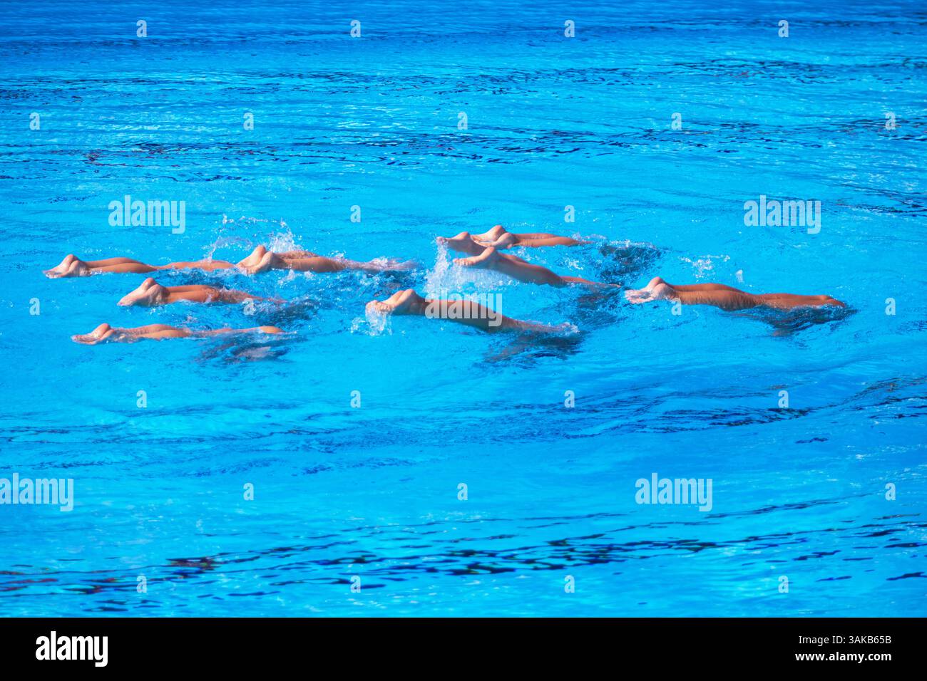 Synchronized or artistic swimmers perform an elegant upside-down ...