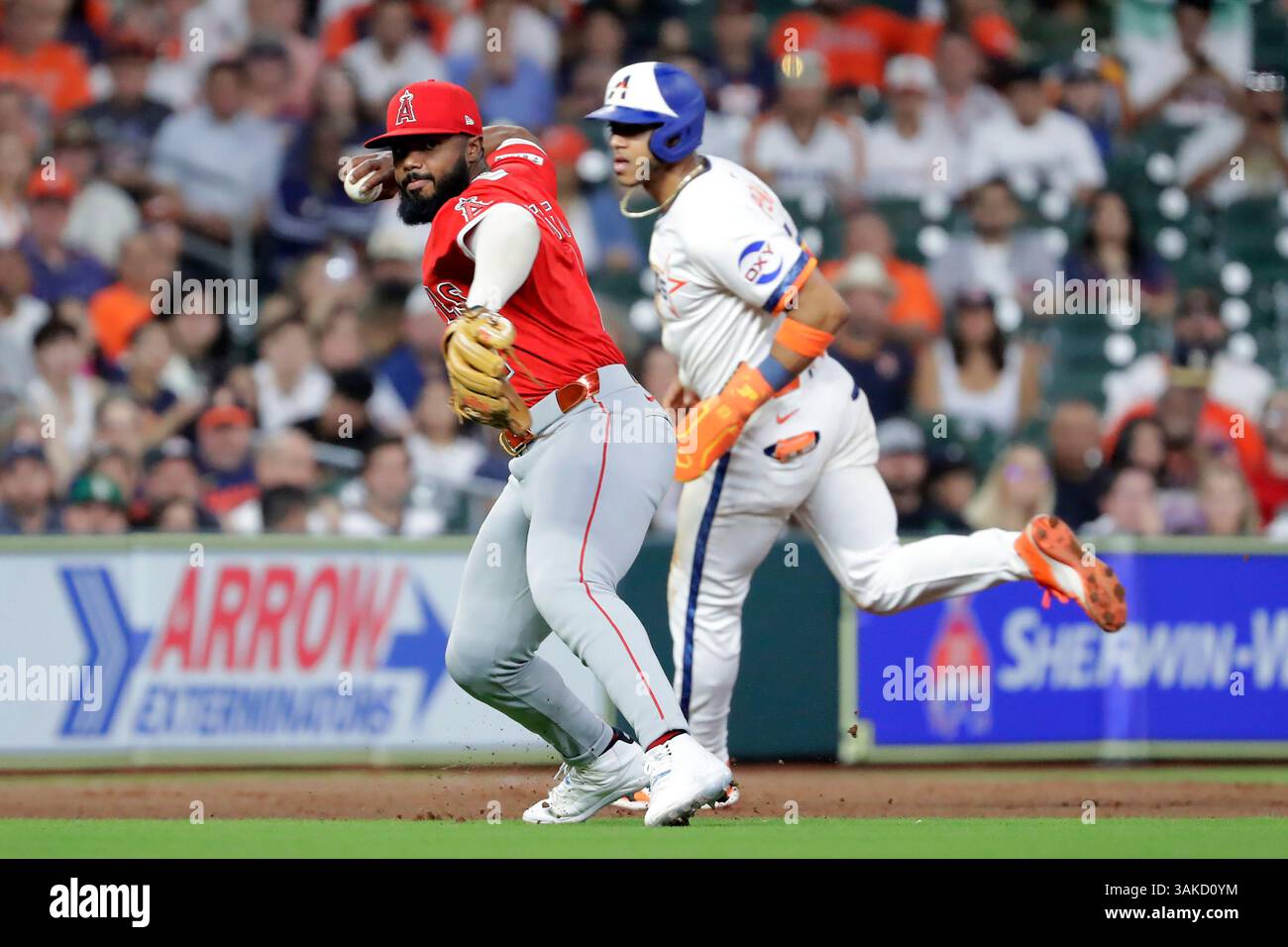 Los Angeles Angels third baseman Luis Rengifo, left, makes the throw to ...