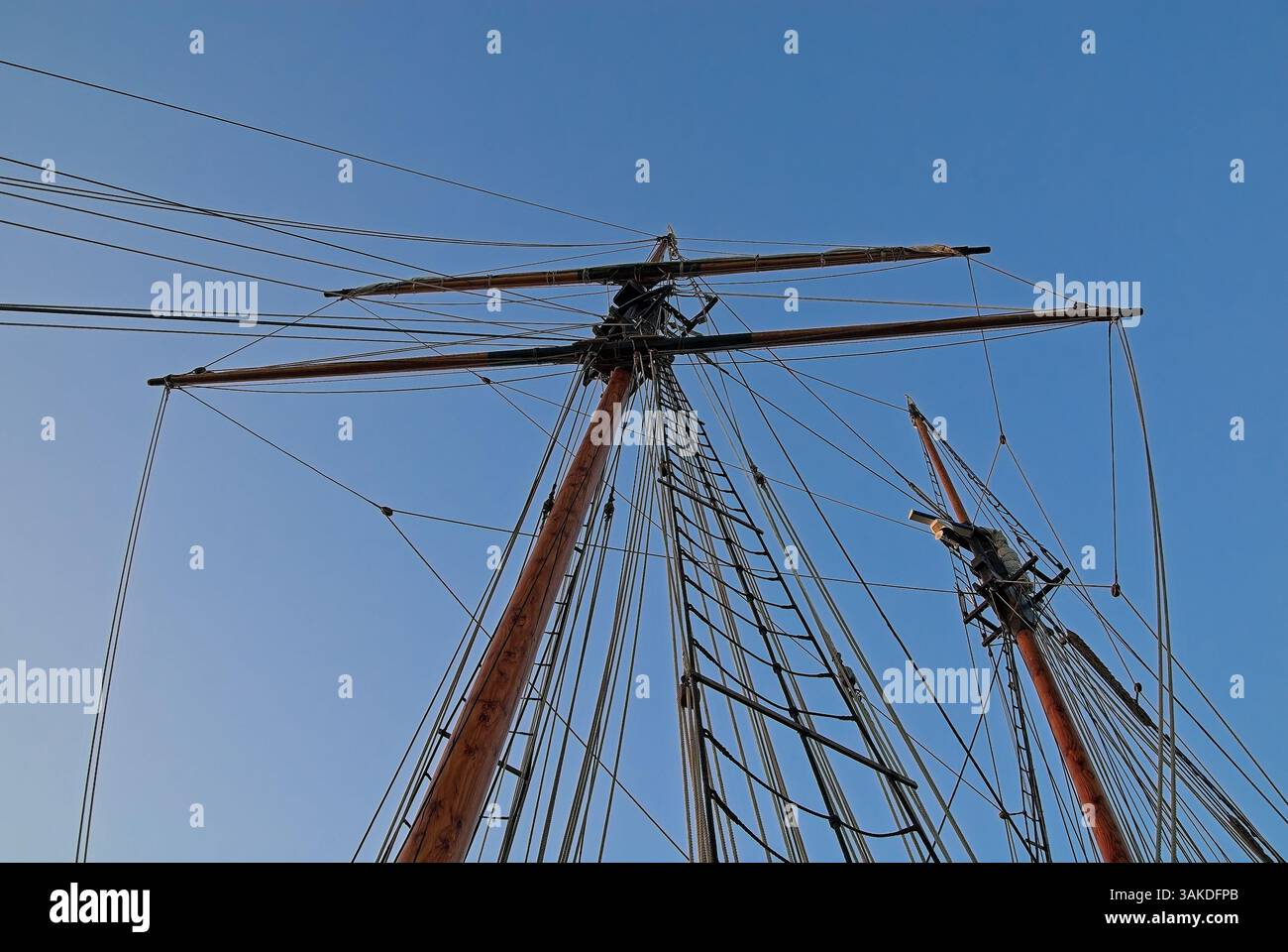 Looking up at square rig mast and yard with rigging of sailing ship set ...