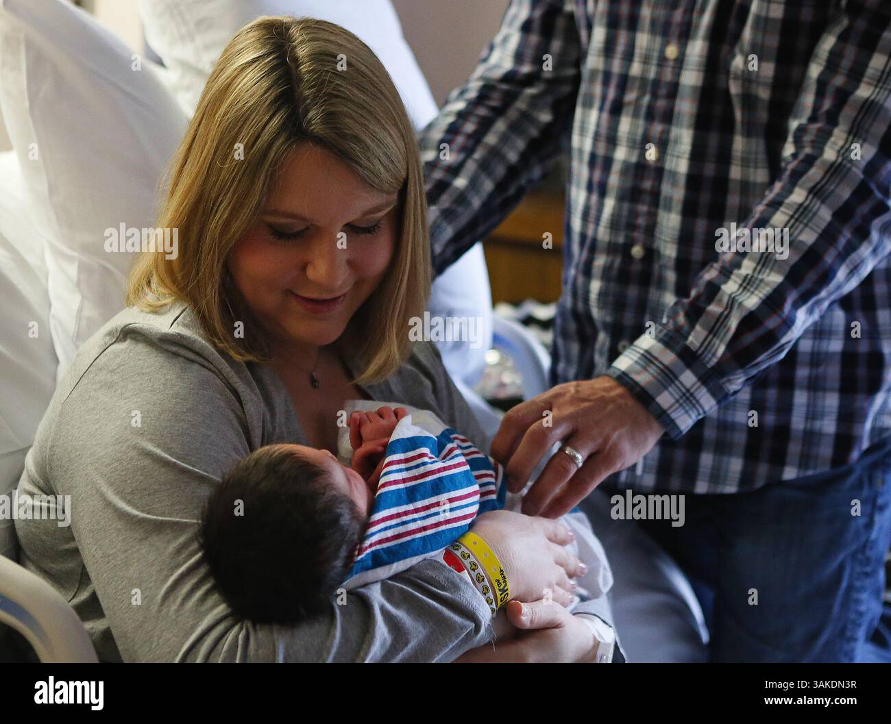 May 4, 2017 - Akron, OH, USA - Erin and Tony Maroon admire their newborn baby, Anthony Jerrick Maroon, on May 4, 2017, at Summa Akron City Hospital in Akron, Ohio. Erin and Tony have donated a CuddleCot, a refrigerated bassinet that allows grieving parents of stillborn babies to be with their baby longer after the loss, to Akron Children's Hospital. The couple started a a foundation after they only had a few hours to be with their baby, who died in 2015, to provide these bassinets. (Credit Image: © Leah Klafczynski/TNS via ZUMA Wire) Stock Photo