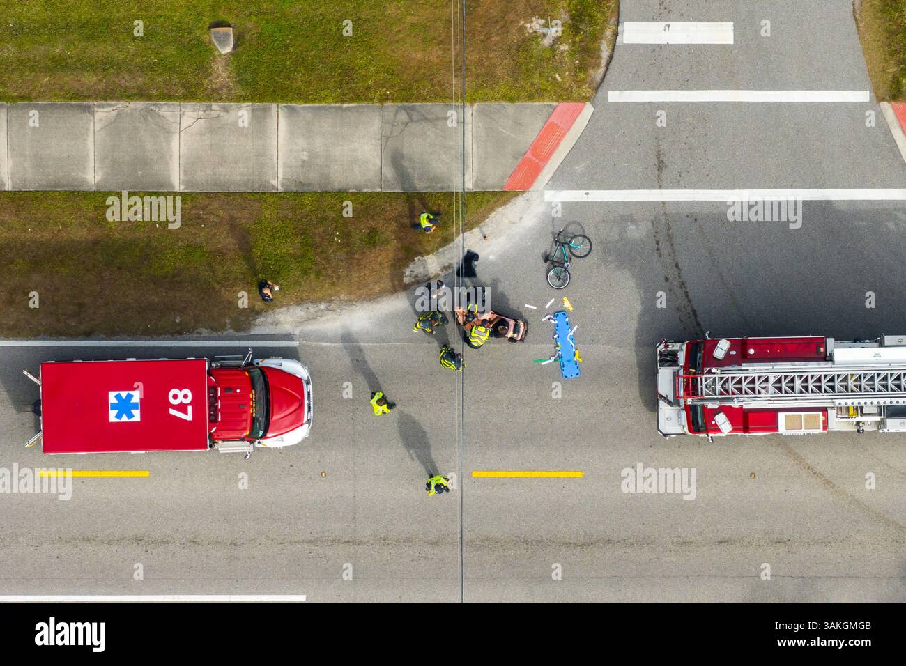 Car crash with first responders helping cyclist on a stretcher who was ...