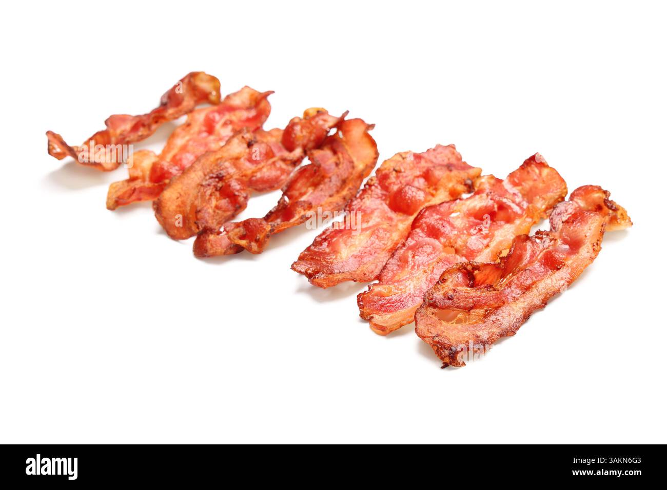 Many fried bacon rashers on white background Stock Photo - Alamy