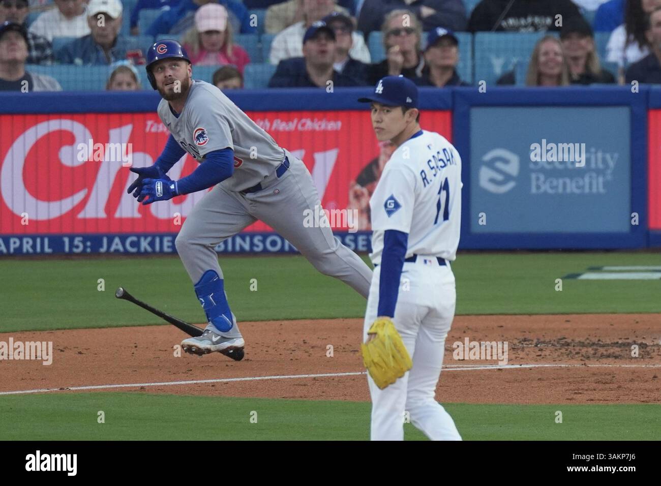 Chicago Cubs' Michael Busch, left, heads to first a solo home run as ...