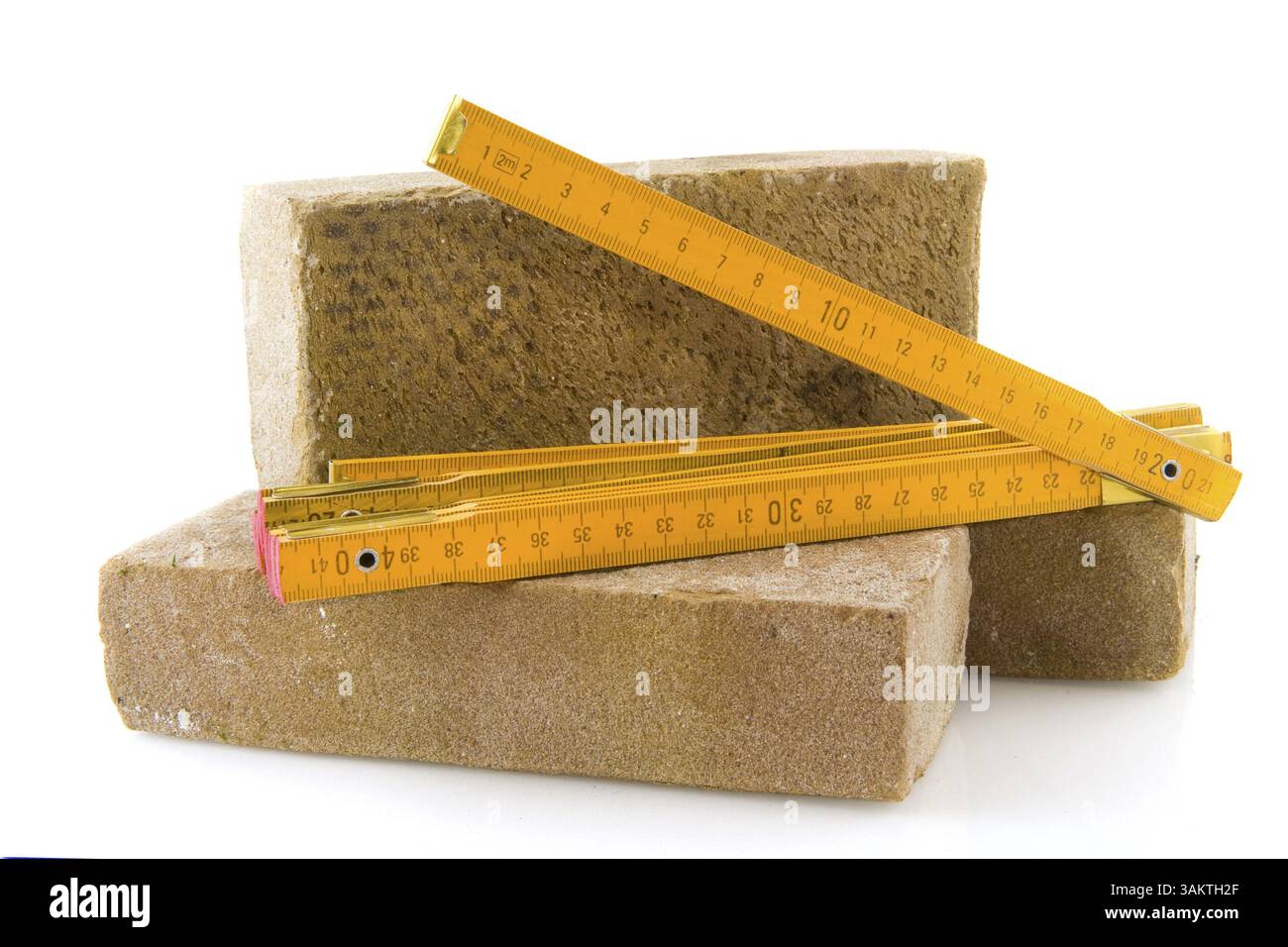 Bricks for building a house and measuring tool Stock Photo
