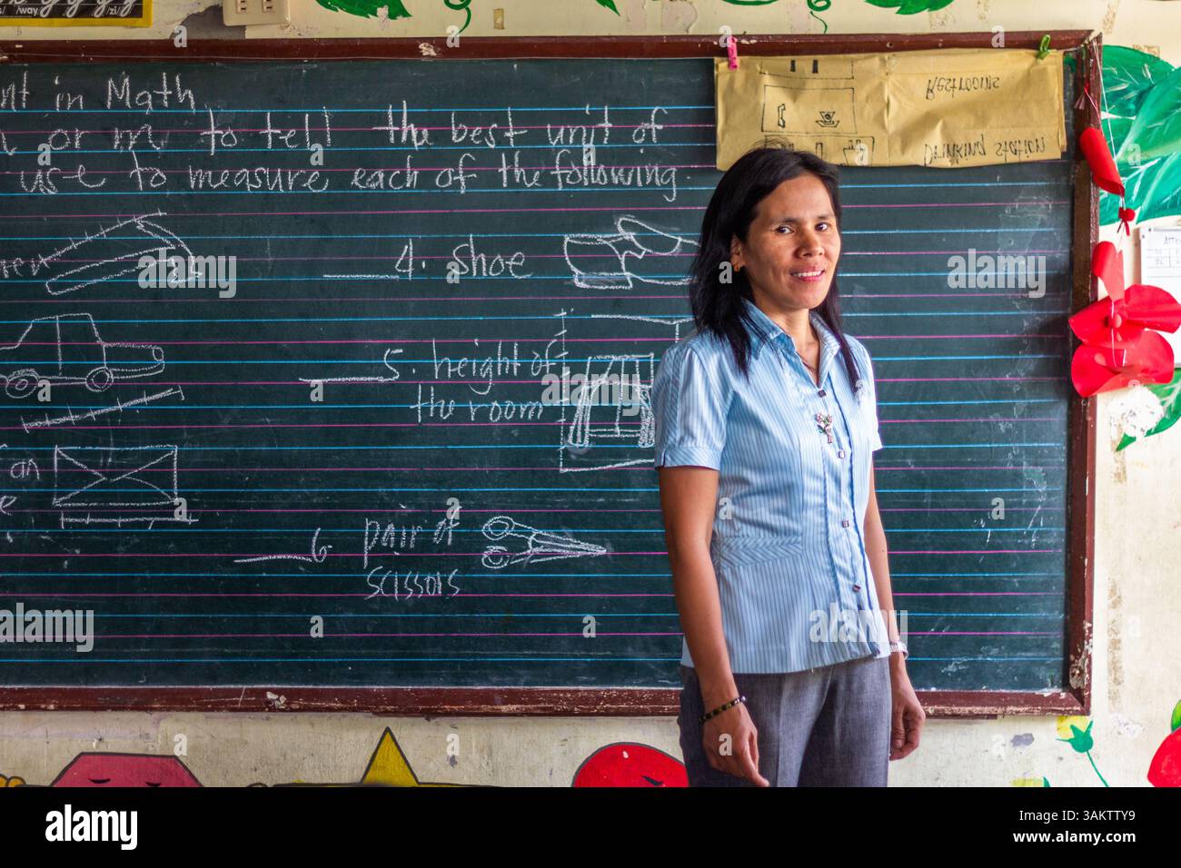 A portrait of a public school teacher in Batangas, Philippines, highlighting dedication to education and community service in a rural school setting Stock Photo