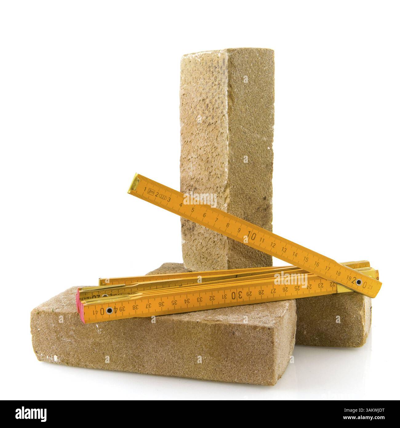 Bricks and measurement tool isolated over white Stock Photo