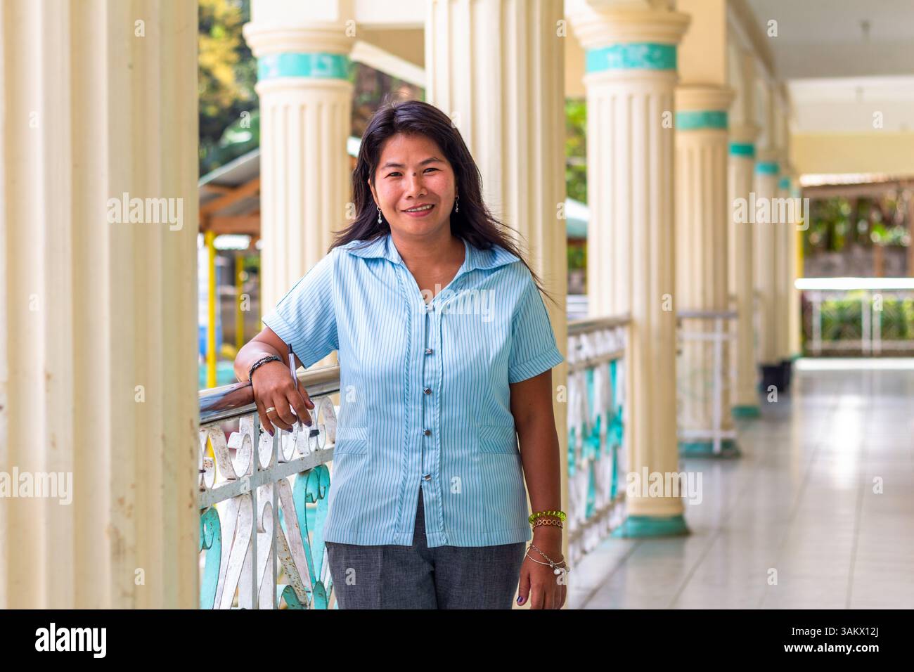 A portrait of a public school teacher in Batangas, Philippines, highlighting dedication to education and community service in a rural school setting Stock Photo