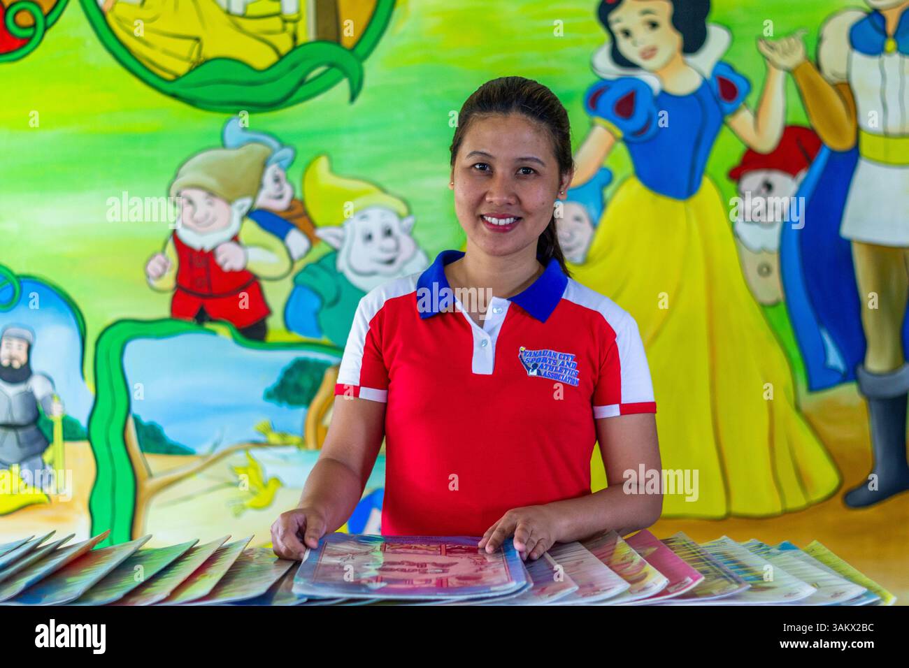 A portrait of a public school teacher in Batangas, Philippines, highlighting dedication to education and community service in a rural school setting Stock Photo
