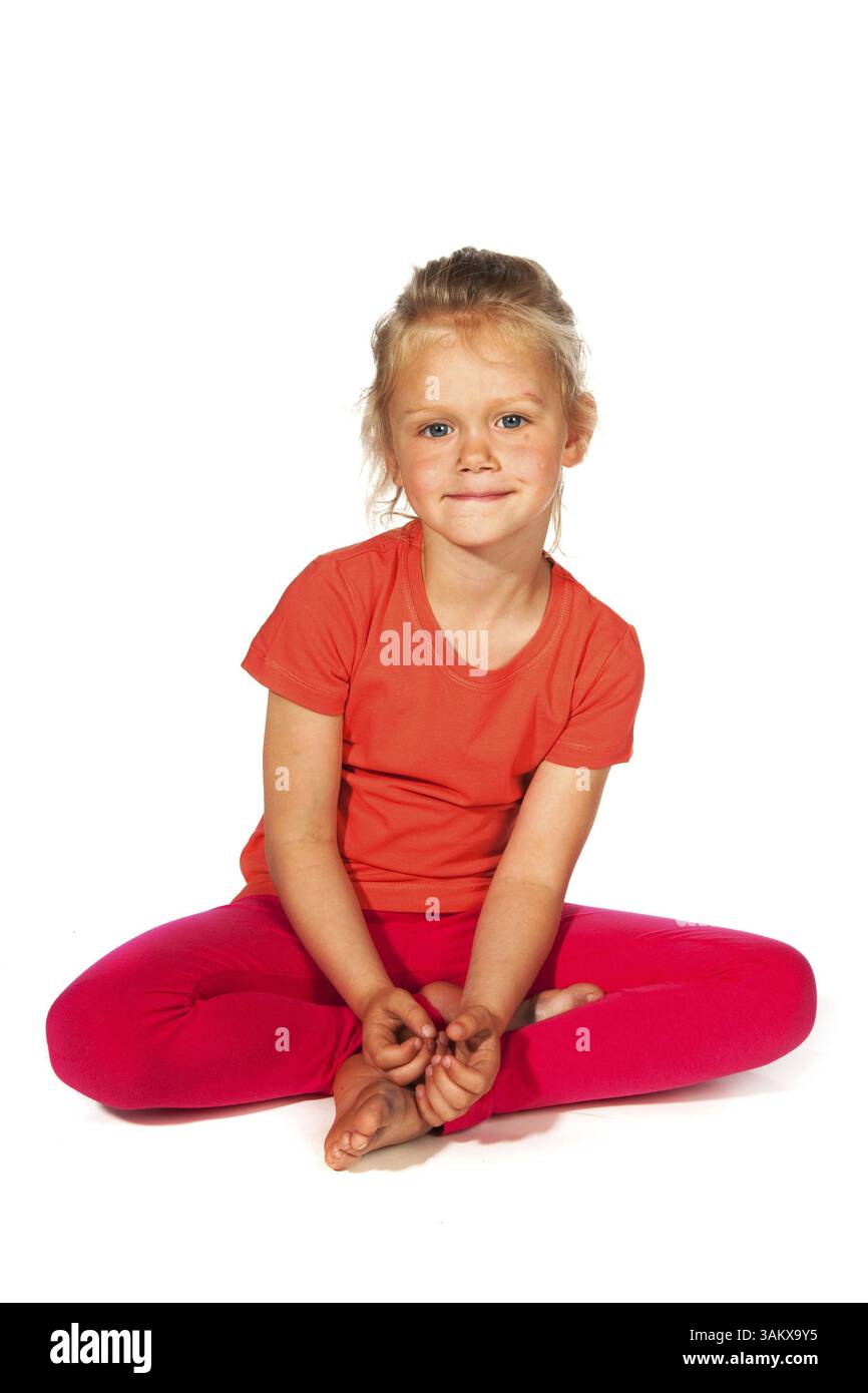 Lovely blond girl sitting at the floor Stock Photo - Alamy