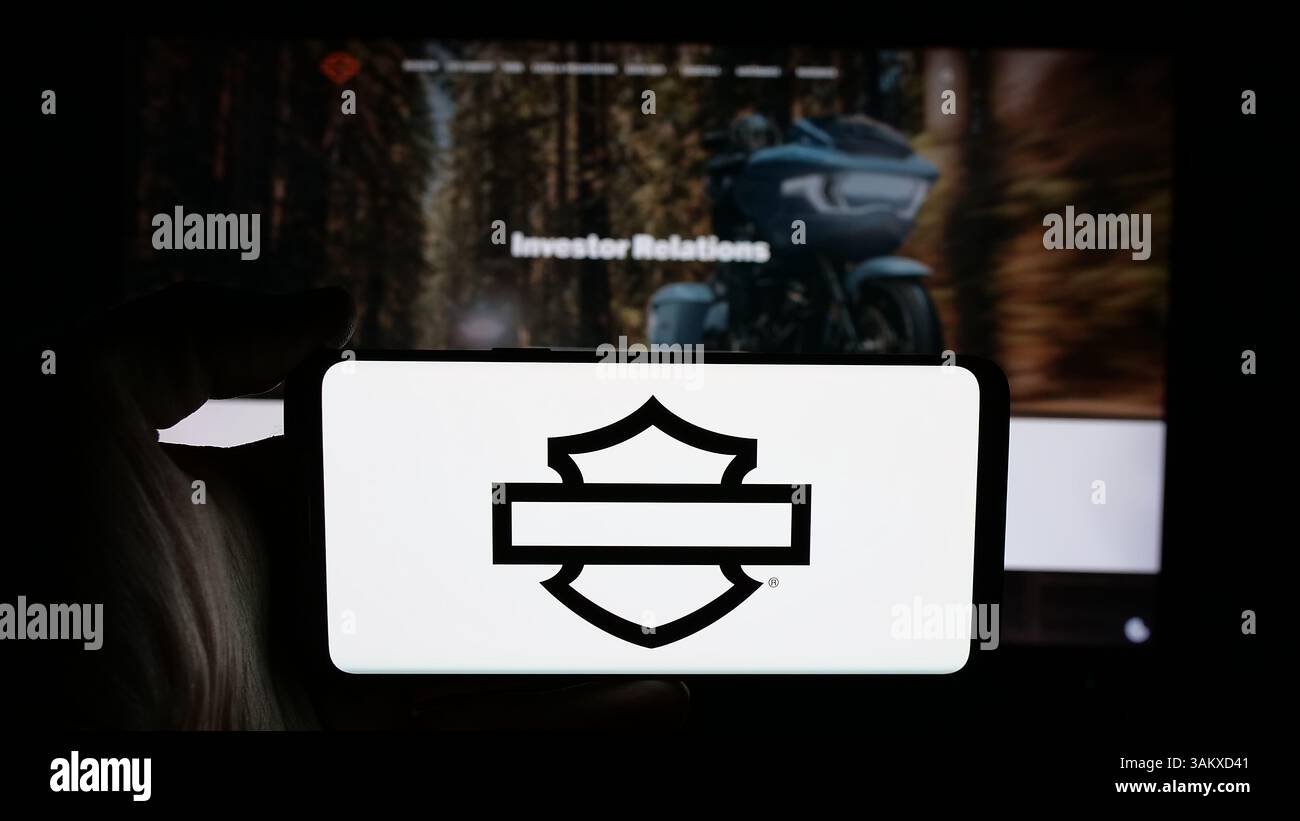 Stuttgart, Germany - 11-26-2024: Person holding cellphone with logo of US motorcycle company Harley-Davidson Inc. on screen Stock Photo